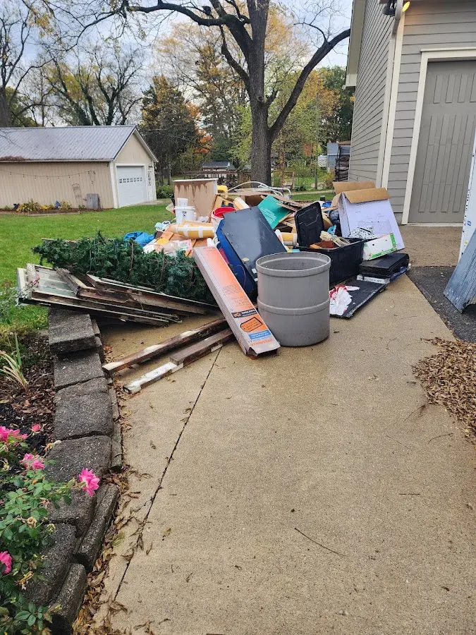 Dumpster being loaded with debris for 12 Yard Dumpster Rental in Mendota